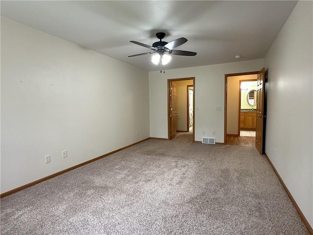 unfurnished bedroom featuring visible vents, a ceiling fan, baseboards, and light carpet