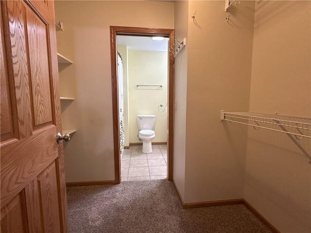 walk in closet featuring carpet floors and tile patterned flooring