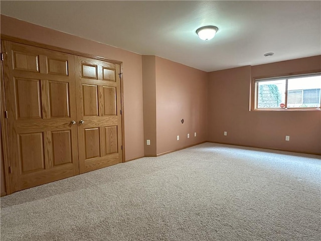 unfurnished bedroom with baseboards and carpet flooring