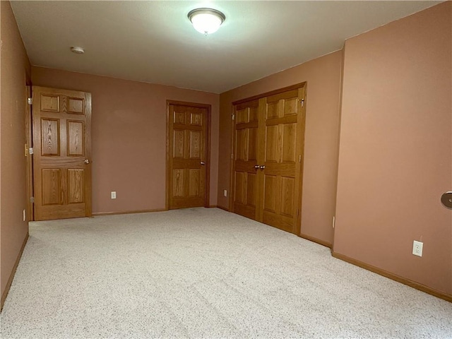 carpeted spare room with baseboards