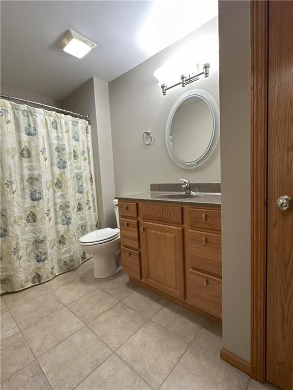 bathroom featuring a shower with curtain, tile patterned floors, vanity, and toilet