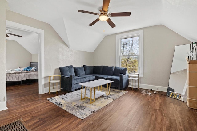 living room with ceiling fan, vaulted ceiling, and wood finished floors