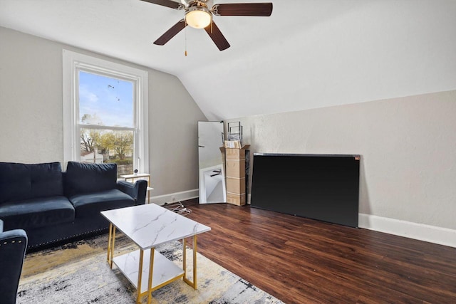living room featuring baseboards, ceiling fan, wood finished floors, and lofted ceiling