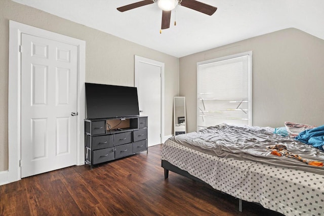 bedroom with a ceiling fan and dark wood-style floors