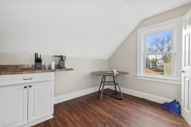 bonus room with baseboards, vaulted ceiling, and dark wood-style flooring