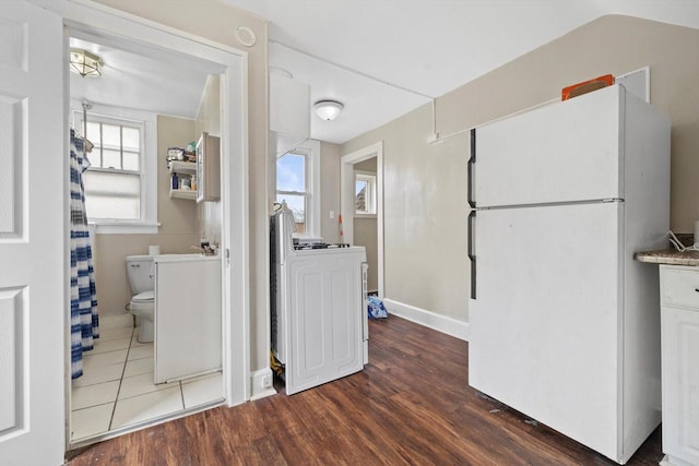 interior space featuring baseboards and wood finished floors