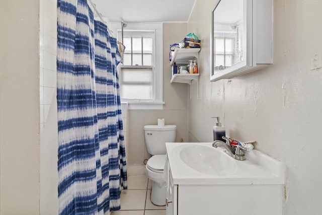 full bathroom with toilet, tile patterned floors, curtained shower, and vanity