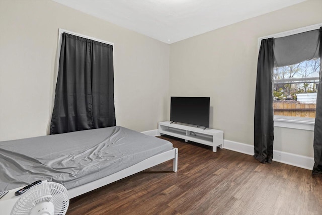 bedroom featuring baseboards and wood finished floors