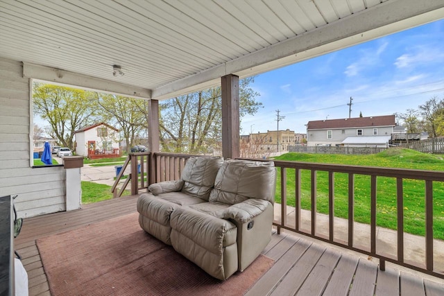 deck with a lawn and fence