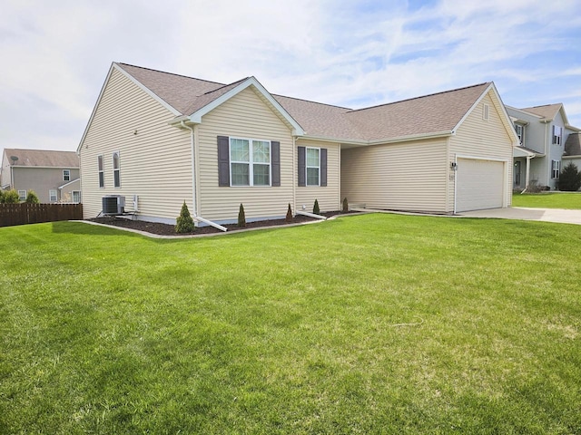 ranch-style home featuring driveway, a front yard, fence, cooling unit, and an attached garage