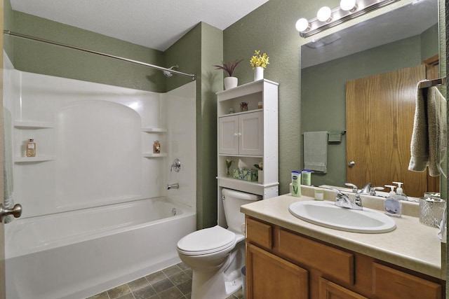 bathroom with vanity, a textured wall, shower / bathtub combination, and toilet