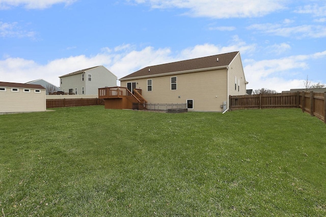 rear view of house featuring stairs, a fenced backyard, a wooden deck, and a yard