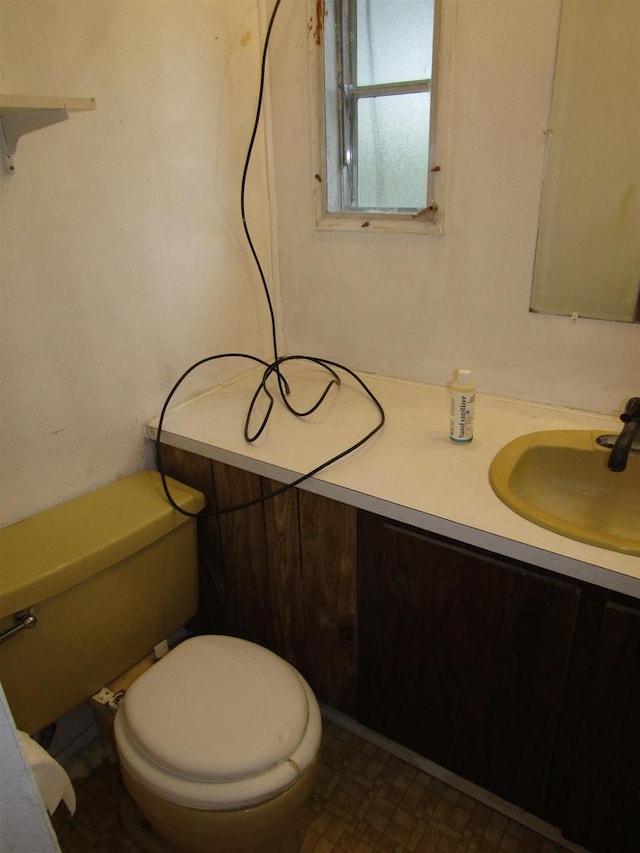 half bath featuring vanity and toilet