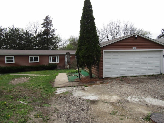 view of front of property with log veneer siding and a garage