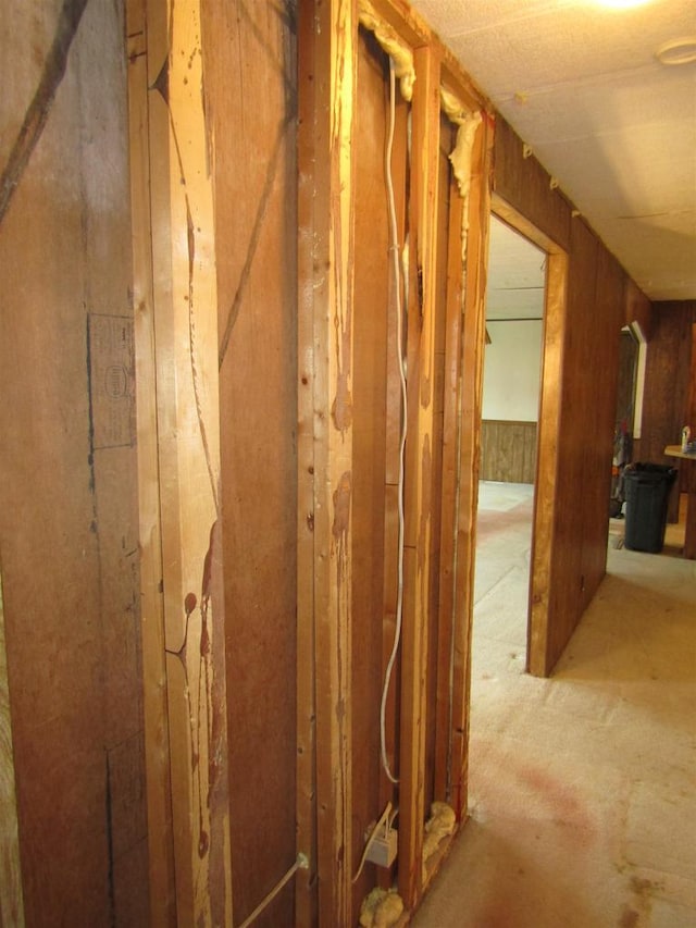 hallway with wood walls