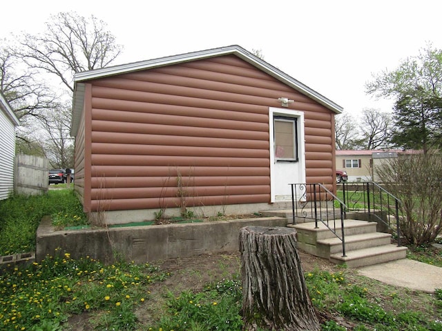 view of side of property featuring log veneer siding