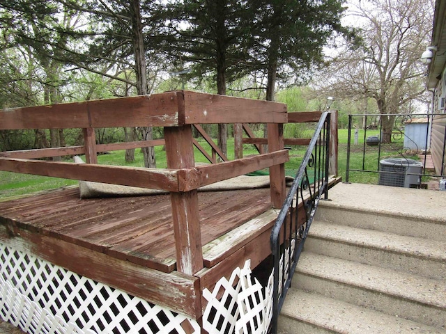 wooden deck featuring cooling unit