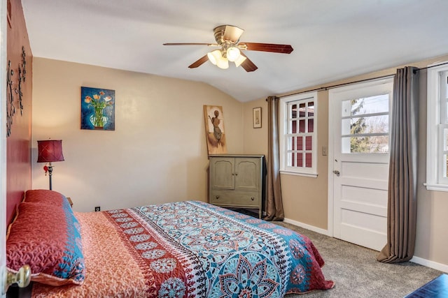carpeted bedroom featuring lofted ceiling, baseboards, and ceiling fan