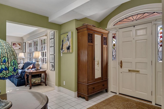 entrance foyer featuring baseboards and light tile patterned floors