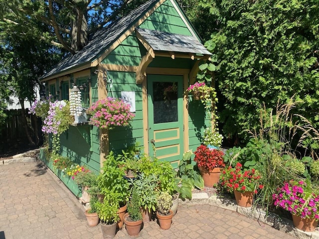view of outdoor structure with an outbuilding and fence