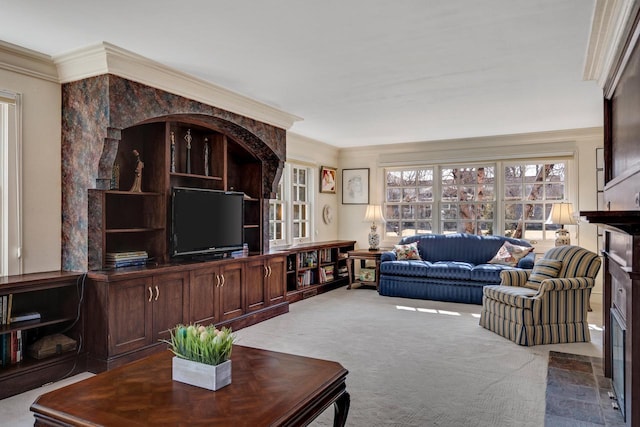 living room with ornamental molding and carpet