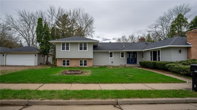1413 E Clairemont Ave, Eau Claire, WI 54701 - split level home featuring a fire pit, a garage, a chimney, and a front yard