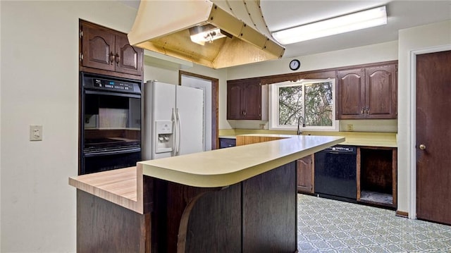 1413 E Clairemont Ave, Eau Claire, WI 54701 - kitchen with black appliances, light countertops, under cabinet range hood, and dark brown cabinetry