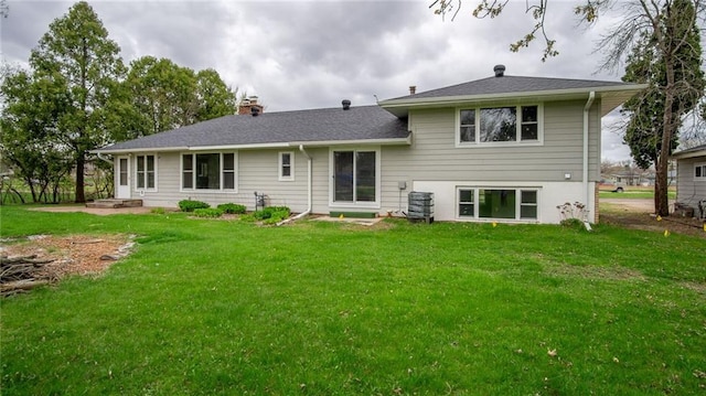 1413 E Clairemont Ave, Eau Claire, WI 54701 - back of property with a lawn, a chimney, and central AC