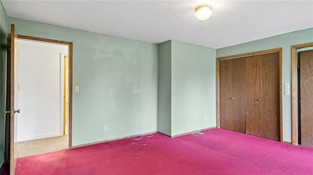 1413 E Clairemont Ave, Eau Claire, WI 54701 - unfurnished bedroom featuring carpet, a textured ceiling, and baseboards