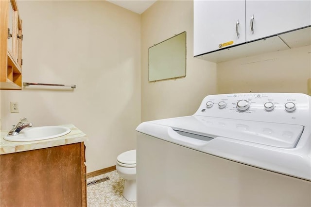 E5081 865th St, Boyceville, WI 54725 - washroom featuring a sink, washer / clothes dryer, laundry area, visible vents, and baseboards