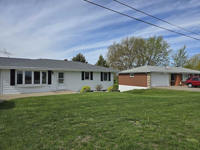 exterior space featuring a lawn, brick siding, and a garage