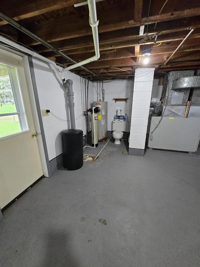 below grade area with heating unit and electric water heater