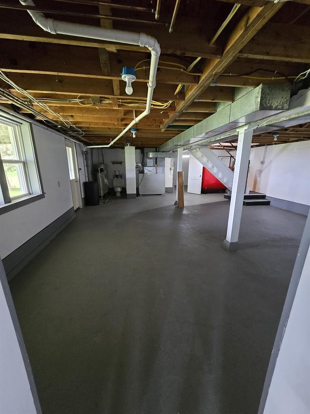 below grade area with heating unit, water heater, and stairway
