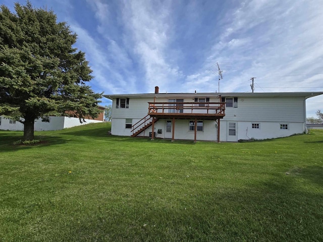 rear view of house featuring a lawn, stairs, and a deck