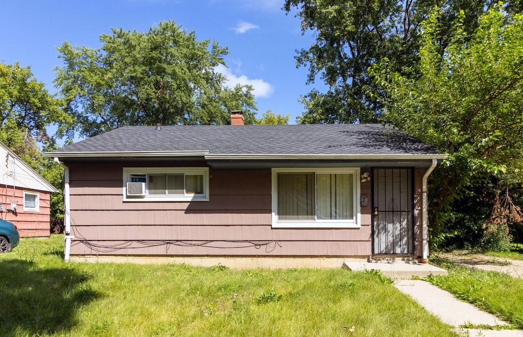 5724 N 62nd St, Milwaukee, WI 53218 - view of front of home with a chimney, a front yard, and a shingled roof