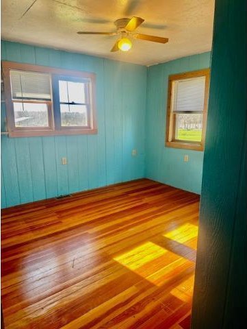 spare room featuring ceiling fan and wood finished floors