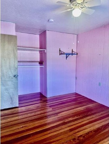 interior space featuring ceiling fan and wood finished floors
