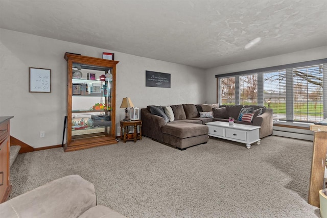 carpeted living area with a baseboard radiator, a textured ceiling, and baseboards