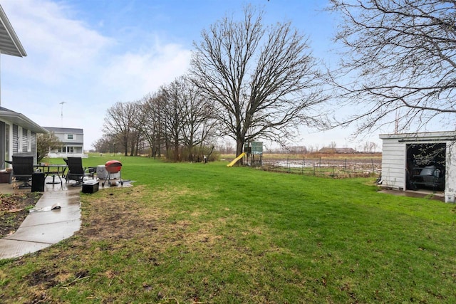 view of yard with fence and a playground