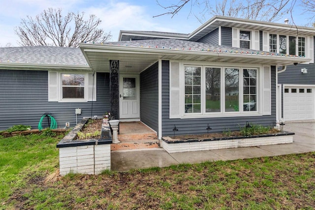 view of front of home with concrete driveway and roof with shingles