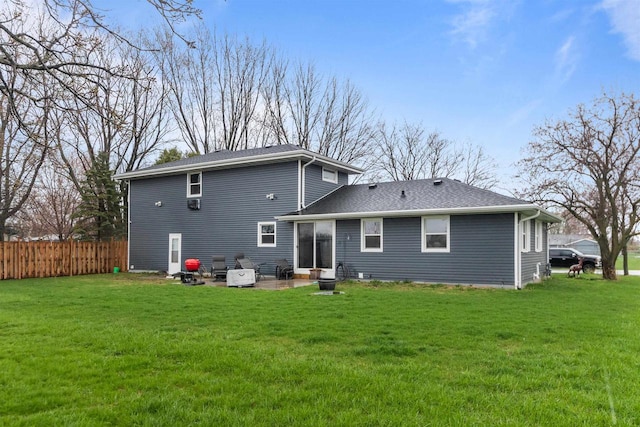 back of property featuring a patio area, fence, and a lawn