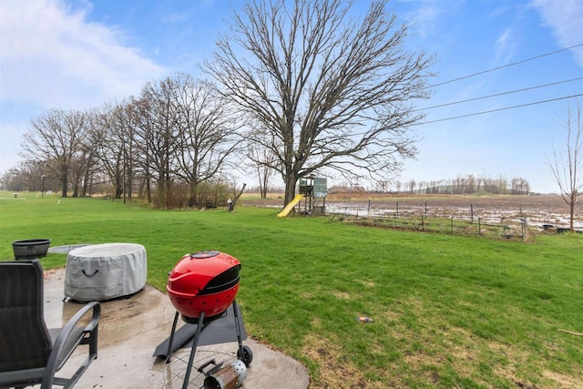 view of yard with a playground and a rural view