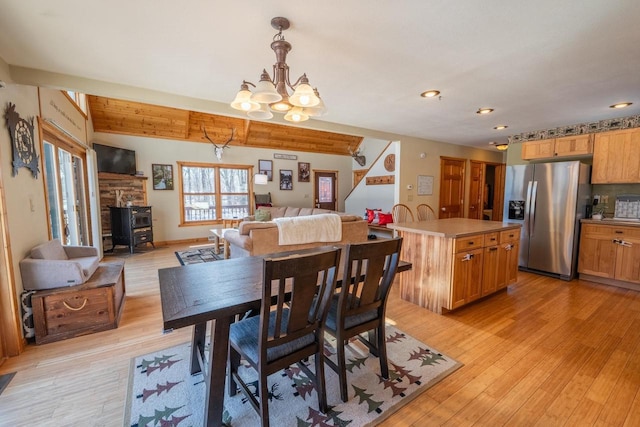 9327 Strong Rd, Argonne, WI 54511 - dining space featuring a wood stove, an inviting chandelier, light wood-type flooring, and recessed lighting