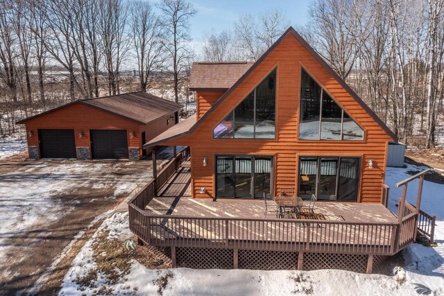 9327 Strong Rd, Argonne, WI 54511 - snow covered property with an outbuilding, a deck, and a detached garage