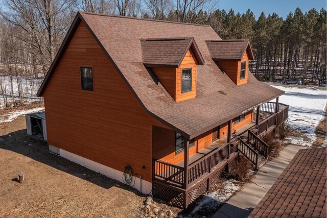 9327 Strong Rd, Argonne, WI 54511 - snow covered property with a porch and roof with shingles