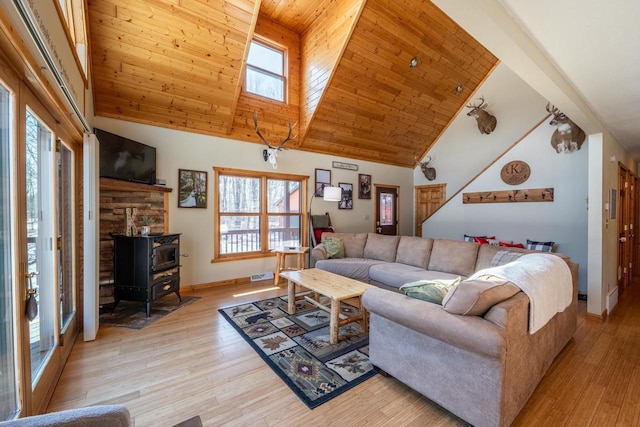9327 Strong Rd, Argonne, WI 54511 - living room with baseboards, a wood stove, and a healthy amount of sunlight
