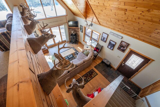 9327 Strong Rd, Argonne, WI 54511 - living room with a wood stove, wooden ceiling, wood finished floors, and high vaulted ceiling