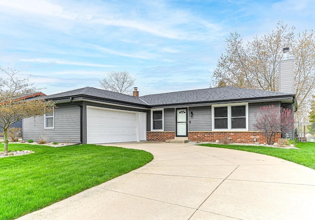 single story home featuring a garage, a chimney, a front lawn, brick siding, and driveway