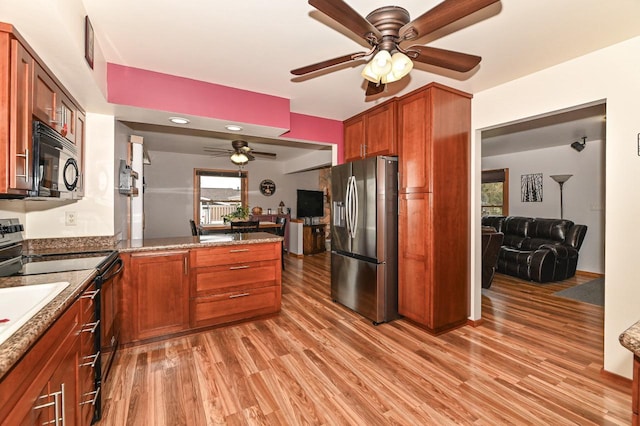 kitchen featuring ceiling fan, light wood-style flooring, black microwave, electric range oven, and stainless steel fridge with ice dispenser