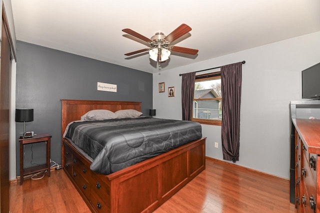 bedroom with light wood-style floors and ceiling fan